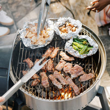 Load image into Gallery viewer, Solo Stove Grill Ultimate Bundle - Top Down View Of The Grill In Use - Charcoal Lit With Food Cooking On The Grill Surface As Grill Utensils Are Used