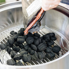 Load image into Gallery viewer, Solo Stove Grill Ultimate Bundle - Close Top Down View As Charcoal Is Poured Into The Grill On The Bottom Rack
