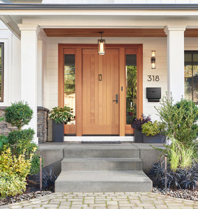 Boyleston LED Path Lights Two Dark Bronze Lights on Display on Each Side of a Front Entrance to a White Home, with Concrete Stairs and Pavers. Front View