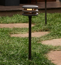 Load image into Gallery viewer, Macadam LED Path Light, One Bronze Light on Display to the Side of a Walkway, In A Garden