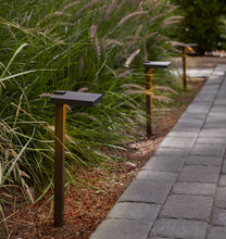 Load image into Gallery viewer, Hamlin LED Path Lights Three Bronze Lights on Display to the Side of a Walkway, In A Garden