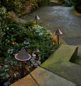 Viola LED Path Lights Three Dark Bronze Lights on Display to the Side of a Walkway, Descending Down Stairs, Near Some Foliage