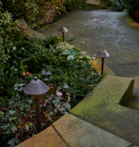 Saratoga LED Path Lights Three Dark Bronze Lights on Display to the Side of a Walkway, Descending Down Stairs, Near Some Foliage