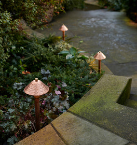 Saratoga LED Path Lights Three Copper Lights on Display to the Side of a Walkway, Descending Down Stairs, Near Some Foliage